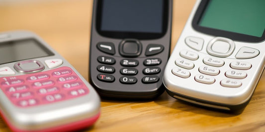 Classic T-Mobile non-smart phones on a table